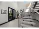Elegant staircase featuring sleek metal railings, neutral decor, and ample natural light at 5 Highland Cove Ln, Henderson, NV 89011