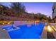 Stunning pool and spa with water features, complemented by lush landscaping and a serene ambiance at 5 Highland Cove Ln, Henderson, NV 89011