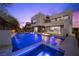 Elegant home featuring a private pool, waterfall, and spacious patio perfect for entertaining or relaxing at 5 Highland Cove Ln, Henderson, NV 89011