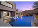 Luxury home showcasing a backyard oasis with a pool, outdoor kitchen, and inviting lounge areas at 5 Highland Cove Ln, Henderson, NV 89011