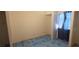 A bright bedroom featuring white walls, unique flooring, and a closet visible through a doorway at 5068 Killarney St, Las Vegas, NV 89122