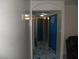 Hallway with archway showing blue interior doors and unique flooring design at 5068 Killarney St, Las Vegas, NV 89122