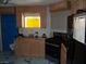Unfinished kitchen featuring light wood cabinets and black appliances at 5068 Killarney St, Las Vegas, NV 89122