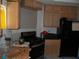 Unfinished kitchen featuring light wood cabinets and black appliances at 5068 Killarney St, Las Vegas, NV 89122