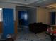 Open living room area featuring blue doors and unique floor and wall designs at 5068 Killarney St, Las Vegas, NV 89122