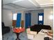 Spacious living room with unique flooring, seating, and blue interior doors at 5068 Killarney St, Las Vegas, NV 89122