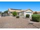 Inviting one-story home with a two car garage, desert landscaping, and solar panels on the roof at 5117 Axbridge Ct, North Las Vegas, NV 89031