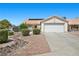 Charming single-story home featuring a well-manicured yard, two car garage, and desert landscaping at 5117 Axbridge Ct, North Las Vegas, NV 89031