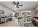 Bright kitchen featuring tile flooring, a ceiling fan, and glass sliding doors to the backyard patio at 5117 Axbridge Ct, North Las Vegas, NV 89031