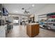 Open kitchen with a center island, pantry, stainless steel appliances, and sliding glass door access to the backyard at 5117 Axbridge Ct, North Las Vegas, NV 89031
