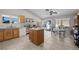 Bright kitchen features stainless appliances, an island, a ceiling fan and a dining area at 5117 Axbridge Ct, North Las Vegas, NV 89031