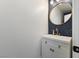 Stylish half-bathroom with modern vanity, elegant mirror, and decorative wallpaper at 5131 Moose Falls Dr, Las Vegas, NV 89141