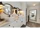 Luxurious bathroom with double sinks, marble countertop, and stylish lighting fixtures at 5131 Moose Falls Dr, Las Vegas, NV 89141