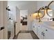 Bright bathroom with double sinks, white cabinetry and access to the bedroom at 5131 Moose Falls Dr, Las Vegas, NV 89141