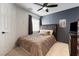 Bedroom with wooden headboard, carpet flooring and dark accent wall at 5131 Moose Falls Dr, Las Vegas, NV 89141