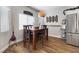 Cozy dining area with wood floors, stylish light fixture and stainless steel refrigerator at 5131 Moose Falls Dr, Las Vegas, NV 89141