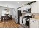 Well-lit kitchen features stainless steel appliances, white cabinetry, and a dining area at 5131 Moose Falls Dr, Las Vegas, NV 89141