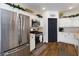 A modern kitchen with stainless steel appliances, white cabinetry, and wood-look floors at 5131 Moose Falls Dr, Las Vegas, NV 89141