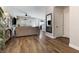 Open-concept living area with a view of the kitchen, hardwood flooring, and a mirror at 5131 Moose Falls Dr, Las Vegas, NV 89141
