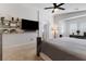 Spacious main bedroom with wall-mounted TV, shelves, and large windows for natural light at 5131 Moose Falls Dr, Las Vegas, NV 89141