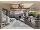 Inviting covered patio with ceiling fans, outdoor seating, and a built-in grill, perfect for entertaining at 5131 Moose Falls Dr, Las Vegas, NV 89141