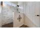 Beautiful shower with tiled walls and pebble floor, providing a spa-like feel at 5131 Moose Falls Dr, Las Vegas, NV 89141