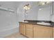Bathroom features double sinks, granite countertops, and tub with shower at 519 Landra Ln, Henderson, NV 89015
