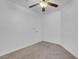 This carpeted bedroom features a ceiling fan and standard door at 519 Landra Ln, Henderson, NV 89015