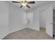 This carpeted bedroom features a ceiling fan and closet at 519 Landra Ln, Henderson, NV 89015