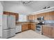 Charming kitchen with stainless appliances, oak cabinets, and modern lighting fixtures at 519 Landra Ln, Henderson, NV 89015