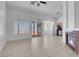 Open-concept living area with tile flooring, a fireplace, and a view of the patio and kitchen at 519 Landra Ln, Henderson, NV 89015