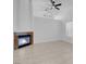 Bright living room featuring a modern fireplace, vaulted ceiling, and neutral tile flooring at 519 Landra Ln, Henderson, NV 89015