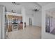 Open living area with kitchen view, ceiling fans, and abundant natural light at 519 Landra Ln, Henderson, NV 89015