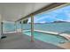 View of covered patio, clear blue pool and blue privacy wall at 519 Landra Ln, Henderson, NV 89015