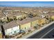 Residential aerial showcases houses in a neighborhood, highlighting roof styles and backyard landscaping at 599 Wounded Star Ave, Las Vegas, NV 89178