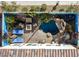 Aerial view of a home featuring a backyard oasis with a pool, fire pit, and lush landscaping at 599 Wounded Star Ave, Las Vegas, NV 89178