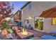 Inviting backyard featuring a stone patio, fire pit, waterfall feature, and comfortable lounge seating at 599 Wounded Star Ave, Las Vegas, NV 89178