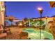 Inviting backyard featuring a stone patio, fire pit, waterfall feature, and comfortable lounge seating at 599 Wounded Star Ave, Las Vegas, NV 89178