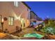 Inviting backyard featuring a stone patio, fire pit, waterfall feature, and comfortable lounge seating at 599 Wounded Star Ave, Las Vegas, NV 89178