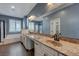 Elegant bathroom featuring a double vanity, soaking tub, glass-enclosed shower, and ample lighting at 599 Wounded Star Ave, Las Vegas, NV 89178