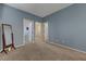 Neutral bedroom with carpet, a mirror, and multiple doorways leading to other rooms at 599 Wounded Star Ave, Las Vegas, NV 89178
