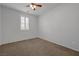 Minimalist bedroom with plush carpet and a bright window at 599 Wounded Star Ave, Las Vegas, NV 89178