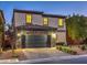 Stylish two-story home with a stone accent, well-manicured landscaping, and a paved driveway at 599 Wounded Star Ave, Las Vegas, NV 89178
