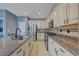 Kitchen features stainless steel appliances, granite countertops, and ample cabinet space at 599 Wounded Star Ave, Las Vegas, NV 89178