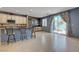 Kitchen with island seating, stylish backsplash, and sliding glass door leading to backyard at 599 Wounded Star Ave, Las Vegas, NV 89178