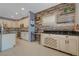 Well-equipped kitchen featuring modern appliances, ample cabinetry, granite counters, and a wooden accent wall at 599 Wounded Star Ave, Las Vegas, NV 89178