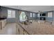Kitchen island with granite countertop, sink, and a view of the living space and backyard at 599 Wounded Star Ave, Las Vegas, NV 89178