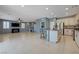 Open floor plan with a modern kitchen with stainless steel appliances and barstool seating at the island at 599 Wounded Star Ave, Las Vegas, NV 89178