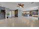 Open-concept layout with tile floors, stairs, and an adjacent kitchen with a breakfast bar at 599 Wounded Star Ave, Las Vegas, NV 89178