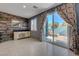 Living room featuring a built-in bar area and a sliding glass door with backyard views at 599 Wounded Star Ave, Las Vegas, NV 89178